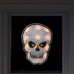 Northlight 12 in. Silver and Black Holographic Lighted Skull Halloween Window Silhouette Decoration thumbnail 2