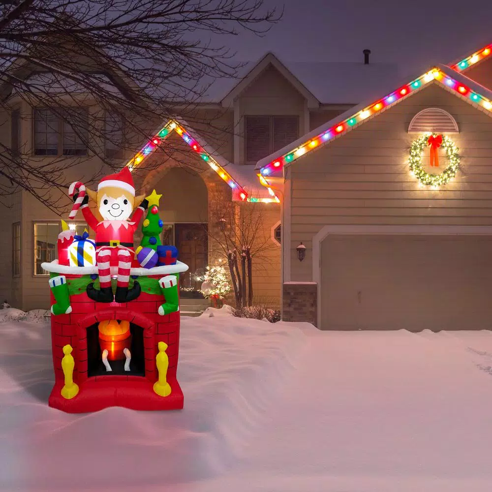 Fraser Hill Farm 6.5 ft. Pre-Lit Elf Sitting on Fireplace Christmas Inflatable