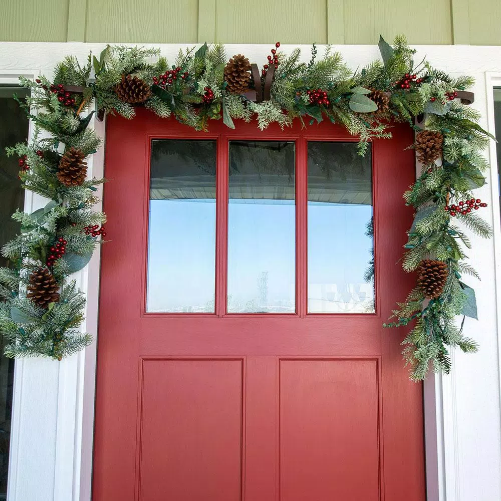 Village Lighting Company 9 ft. Pre-Lit LED Winter Frost Artificial Christmas Garland with Red Berries and Pinecones