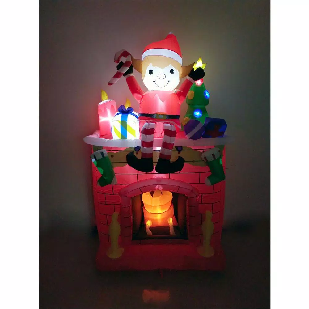 Fraser Hill Farm 6.5 ft. Pre-Lit Elf Sitting on Fireplace Christmas Inflatable