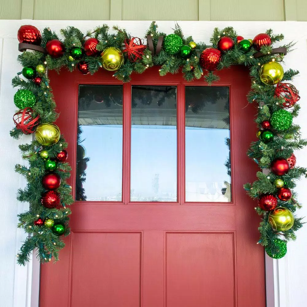 Village Lighting Company 9 ft. Pre-Lit LED Festive Holiday Pine Garland with Red and Green Ornaments