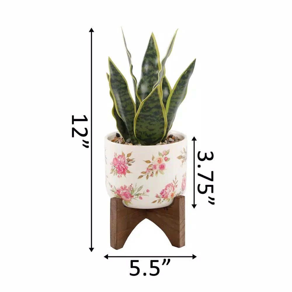 Flora Bunda 12 in. Faux Snake Plant in Floral White Ceramic Pot with Wood Stand