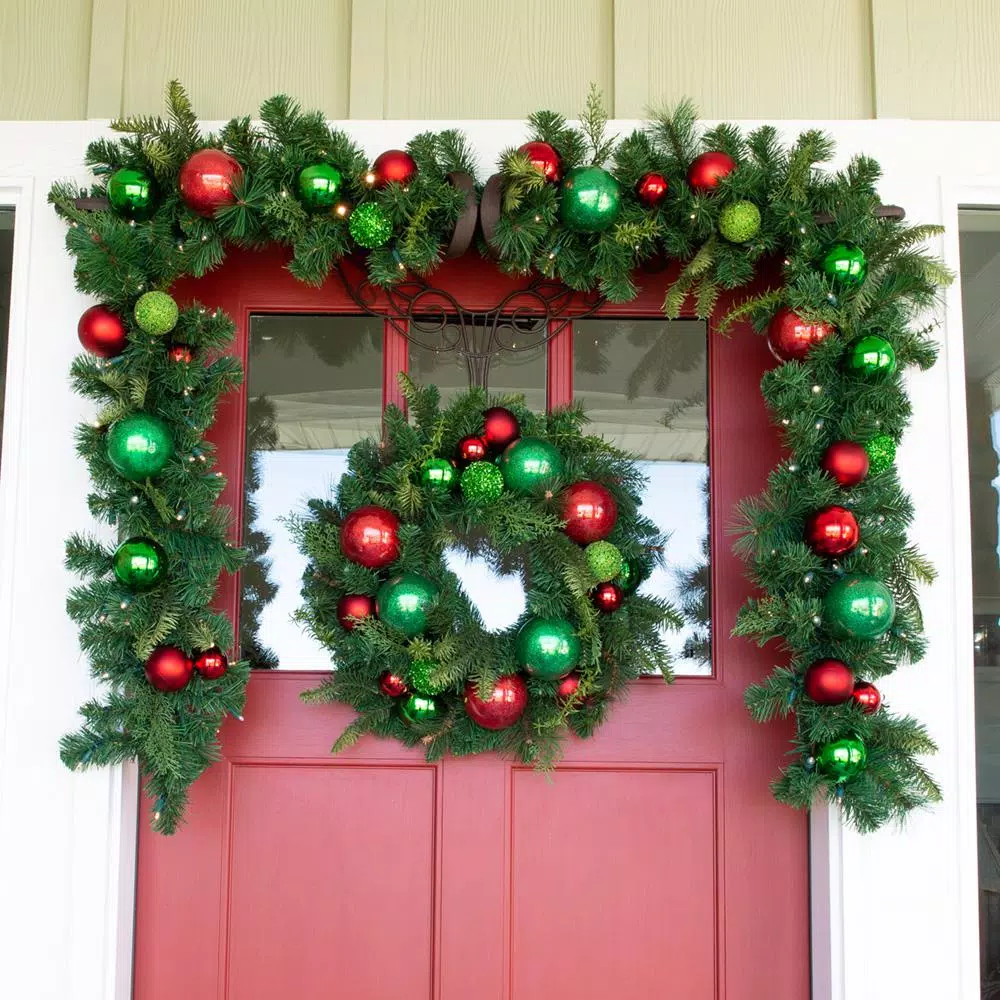 Village Lighting Company 24 in. Red and Green Christmas Cheer Artificial Pine Wreath with Ornaments