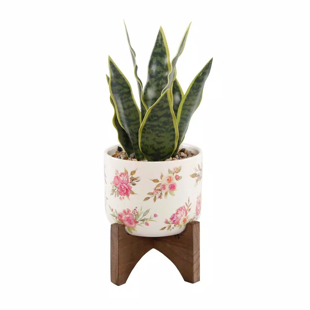 Flora Bunda 12 in. Faux Snake Plant in Floral White Ceramic Pot with Wood Stand
